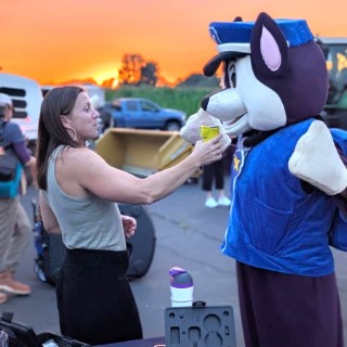 Chem test technician standing with a person in a K9 officer costume.