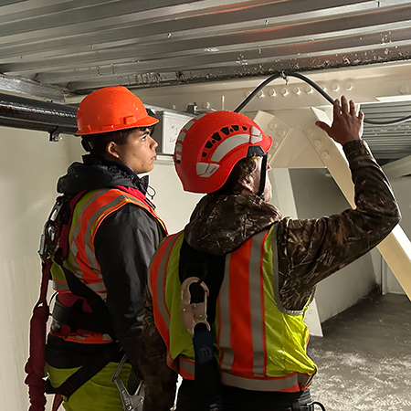 Staff and intern inside bridge tub girders