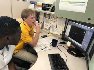 Two interns sitting at a desk.
