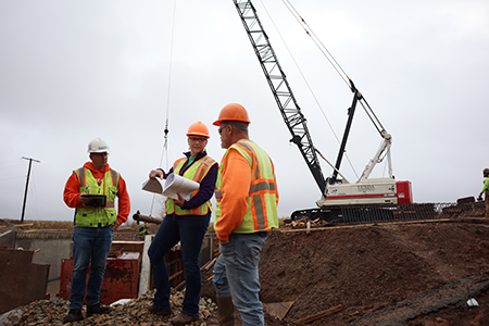 Engineers reviewing plans at a construction site.