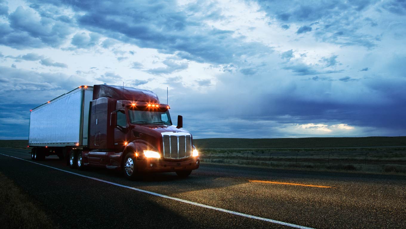Commercial truck on the road in the early evening
