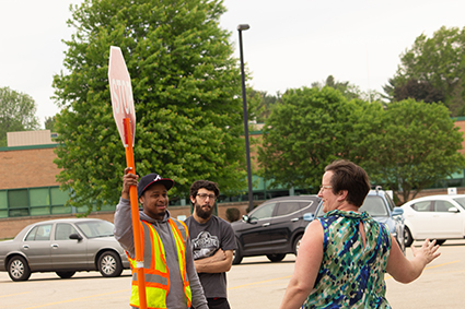 Two students speak to an instructor at a flagging training