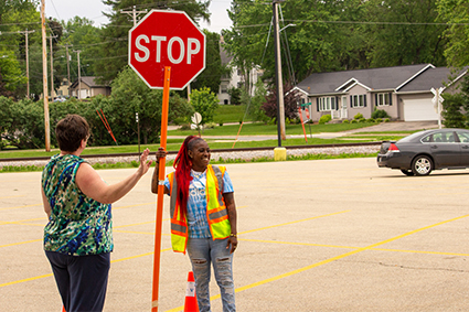 worker hold stop sign for construction