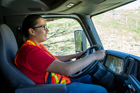 A man driving a semi truck.