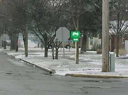 ATV route sign placed near and on the back side of a STOP sign