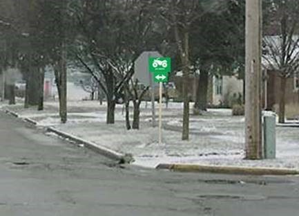 ATV route sign placed near and on the back side of a STOP sign
