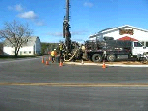 Truck working along side road