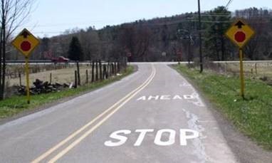 Advanced warning STOP ahead signs placed on both sides of the road