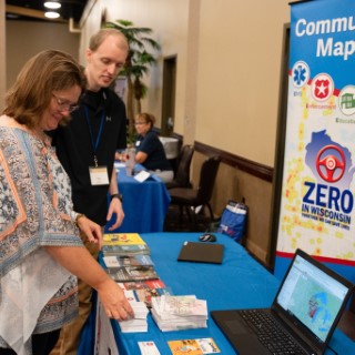 Wisconsin State Patrol staff discuss traffic safety programs at event booth