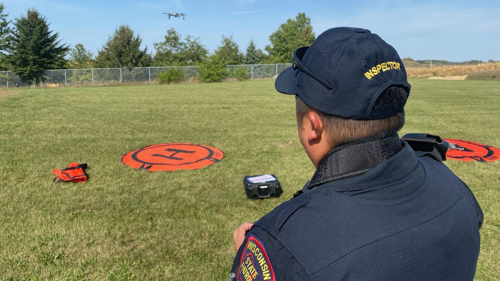 A WSP motor carrier inspector flying a drone from an orange landing pad