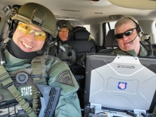 Three WSP SWAT operators riding in a vehicle