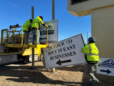 Workers put the detour sign