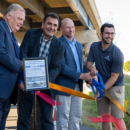WisDOT staff and stakeholders celebrate the completion of a construction project at a ribbon cutting.