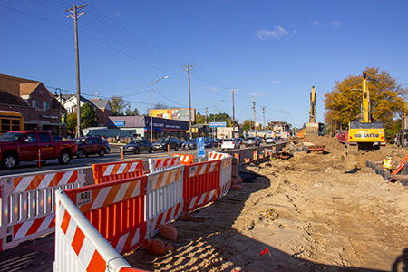 Traffic and businesses next to a busy work zone.